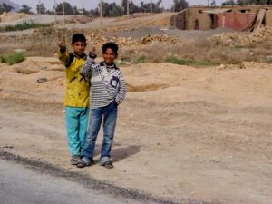 Children in Iraq giving us the peace sign